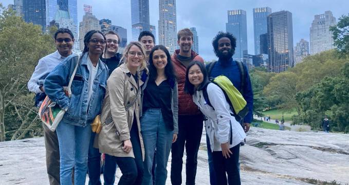 Group posing on Little Island, with Manhattan's skyline in the background.